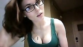 Geeky brunette displays her delicious cleavage in a green t