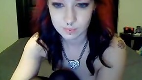 A sexy tattooed redhead beauty has fun with dildo in front of the webcam